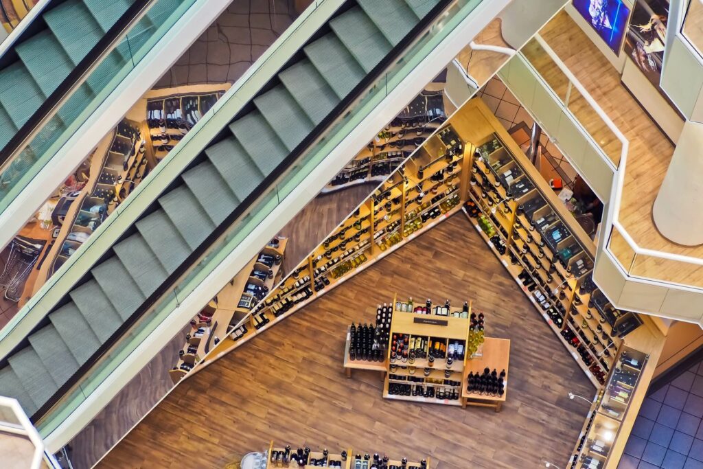 Top down view of a luxury wine store with an escalator at the top left.