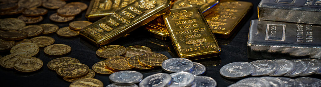 1 oz gold buffalo coins in a gold vault next to 1 oz silver eagle coins